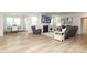 Open-concept living space with a fireplace, plush seating, and a dining area bathed in natural light at 1119 Bellshill Dv, Indian Trail, NC 28079