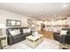 Open-concept living space with hardwood floors, leather furniture, and a view into the kitchen at 1119 Bellshill Dv, Indian Trail, NC 28079