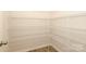 Bright walk-in closet featuring adjustable white wire shelving and light hardwood flooring at 1119 Bellshill Dv, Indian Trail, NC 28079