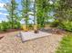Backyard fire pit area with Adirondack chairs and gravel at 1200 Firethorne Club Dr, Marvin, NC 28173
