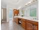 Spacious bathroom features dual sinks, tile floor, and separate vanity area at 1200 Firethorne Club Dr, Marvin, NC 28173