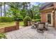 Charming brick patio with dining set and surrounding greenery, perfect for enjoying outdoor meals at 1200 Firethorne Club Dr, Marvin, NC 28173
