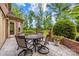 A cozy brick patio features a round table set for four, perfect for outdoor dining and entertaining at 1200 Firethorne Club Dr, Marvin, NC 28173