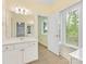 Bright bathroom featuring white vanity, tile floor, and natural light from a large window at 1200 Firethorne Club Dr, Waxhaw, NC 28173