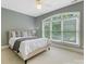 Sunlit bedroom featuring a large window with leafy views and a comfy bed perfect for relaxation at 1200 Firethorne Club Dr, Waxhaw, NC 28173