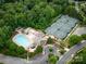 Aerial view of the community pool and tennis courts surrounded by mature trees at 1200 Firethorne Club Dr, Waxhaw, NC 28173