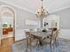 Bright dining room featuring decorative chandelier, area rug, and seating for six at 1200 Firethorne Club Dr, Waxhaw, NC 28173