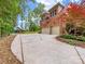 Spacious driveway leading to a brick house with a playground, blending convenience with Gathering fun at 1200 Firethorne Club Dr, Waxhaw, NC 28173