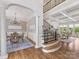 Open-concept foyer featuring hardwood floors, staircase, and dining room at 1200 Firethorne Club Dr, Waxhaw, NC 28173
