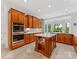 Bright kitchen featuring stainless steel appliances, light countertops, and backyard views at 1200 Firethorne Club Dr, Waxhaw, NC 28173
