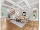 Open living room with coffered ceilings, hardwood floors and neutral tones at 1200 Firethorne Club Dr, Waxhaw, NC 28173