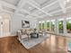 Bright, airy living room featuring coffered ceiling and hardwood floors at 1200 Firethorne Club Dr, Waxhaw, NC 28173