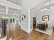 Bright, open living room featuring coffered ceiling, fireplace, and hardwood floors at 1200 Firethorne Club Dr, Waxhaw, NC 28173