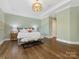 Spacious main bedroom featuring hardwood floors, tray ceiling and accent lighting at 1200 Firethorne Club Dr, Waxhaw, NC 28173