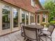 Charming outdoor patio with stone pavers, comfortable seating, and multiple access doors at 1200 Firethorne Club Dr, Waxhaw, NC 28173
