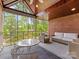 Cozy sunroom with brick accents and plenty of natural light, perfect for relaxation and enjoying the scenery at 1200 Firethorne Club Dr, Waxhaw, NC 28173