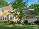 Back exterior view featuring a deck and a well-maintained lawn at 12632 Landing Green Dr, Charlotte, NC 28277