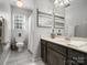 Bathroom showcasing a vanity, mirror, toilet, and shower with curtain at 12632 Landing Green Dr, Charlotte, NC 28277