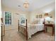 Bedroom showcasing wood-frame bed, chandelier, and two windows at 12632 Landing Green Dr, Charlotte, NC 28277