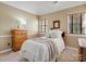 Cozy bedroom with neutral walls, wainscoting, and plush carpet flooring at 12632 Landing Green Dr, Charlotte, NC 28277