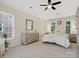 Bright bedroom with neutral decor, a ceiling fan, and ample natural light at 12632 Landing Green Dr, Charlotte, NC 28277