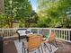 Cozy outdoor deck with seating, wood railing, and lush green surroundings at 12632 Landing Green Dr, Charlotte, NC 28277