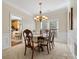 Elegant dining room with a chandelier, neutral carpeting, and views into the kitchen at 12632 Landing Green Dr, Charlotte, NC 28277