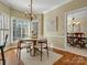 Bright dining room with a round table, chandelier, and large windows at 12632 Landing Green Dr, Charlotte, NC 28277