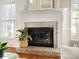 Brick fireplace with a white mantel and decorative accents at 12632 Landing Green Dr, Charlotte, NC 28277