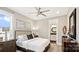 Cozy bedroom with neutral walls, plush carpeting, a comfortable bed, and an attached bath at 13241 Cozy Ct, Charlotte, NC 28215