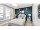 Stylish bedroom with modern decor, a plush bed, large windows, and a unique accent wall at 13241 Cozy Ct, Charlotte, NC 28215