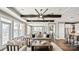 Bright living room with coffered ceiling, exposed beams, large windows, and open to dining and kitchen at 13241 Cozy Ct, Charlotte, NC 28215