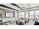 Bright living room with a decorative ceiling, large windows, television, built-in storage, and stylish decor at 13241 Cozy Ct, Charlotte, NC 28215