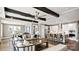 Open-concept living room with large windows, exposed beams, stylish furnishings, and open to the kitchen at 13241 Cozy Ct, Charlotte, NC 28215