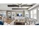Open-concept living room with hardwood floors, ceiling fan, modern furniture, and a view into the bedroom at 13241 Cozy Ct, Charlotte, NC 28215