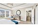 Bright main bedroom with a large window, stylish dresser, and decorative mirror with tray ceiling and recessed lighting at 13241 Cozy Ct, Charlotte, NC 28215