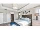 Bright main bedroom with tray ceiling, large windows, and stylish furnishings at 13241 Cozy Ct, Charlotte, NC 28215