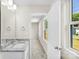 This bathroom has a granite countertop with white cabinets and an open doorway to the bedroom at 1411 Duhart Ave, Gastonia, NC 28054