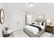 Staged bedroom with area rug, bed with nightstands, lamps, closet, and white accent chair at 1411 Duhart Ave, Gastonia, NC 28054