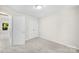 This bedroom features neutral paint and carpet with a double-door closet and an open doorway at 1411 Duhart Ave, Gastonia, NC 28054