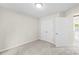 This bedroom features neutral walls, carpet and a closet with double doors for storing clothes and personal items at 1411 Duhart Ave, Gastonia, NC 28054