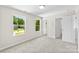 Bright bedroom with soft carpet, bright windows, and ensuite bathroom at 1411 Duhart Ave, Gastonia, NC 28054
