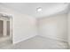 This bedroom has neutral paint and carpet with an open doorway to the hallway at 1411 Duhart Ave, Gastonia, NC 28054