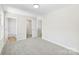 Spacious carpeted bedroom with white walls, and ensuite bathroom and closet at 1411 Duhart Ave, Gastonia, NC 28054