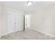 This bedroom features neutral walls, carpet and a closet with double doors for storing clothes and personal items at 1411 Duhart Ave, Gastonia, NC 28054