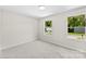 Cozy bedroom with soft carpet, bright windows, and neutral walls at 1411 Duhart Ave, Gastonia, NC 28054