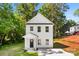 The exterior of this home features white siding, a well-manicured lawn and a driveway for parking at 1411 Duhart Ave, Gastonia, NC 28054