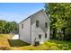 The exterior of this home features a white siding, a back porch and a yard for outdoor activities at 1411 Duhart Ave, Gastonia, NC 28054