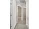 Hallway with neutral paint and carpet, leading to multiple rooms in the home at 1411 Duhart Ave, Gastonia, NC 28054