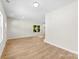 Inviting living room with hardwood floors, neutral paint, with plenty of natural light from an exterior door and a window at 1411 Duhart Ave, Gastonia, NC 28054